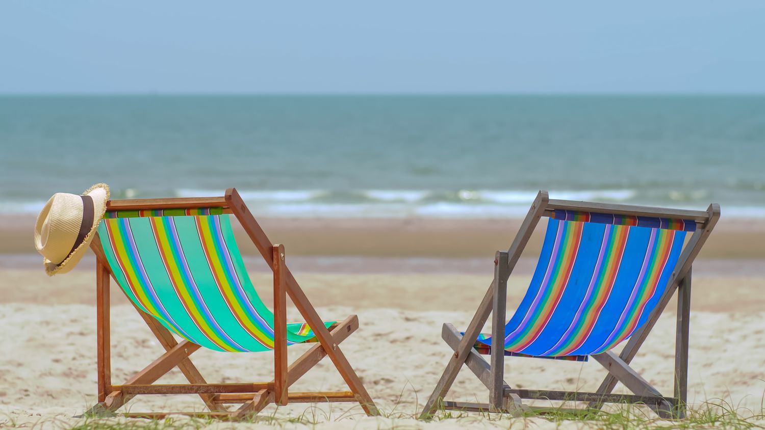01 – sandrew – colorful-beach-chairs-with-hat-on-the-beach-and-se-2023-11-27-05-28-25-utc